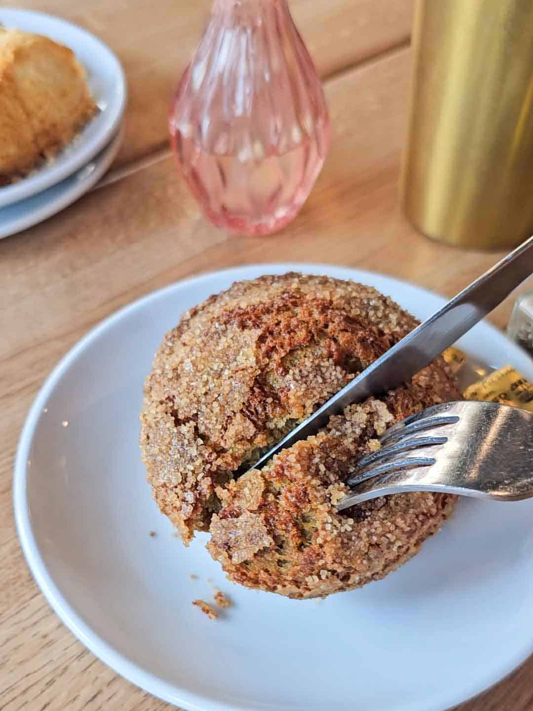 knife cutting a bran muffin