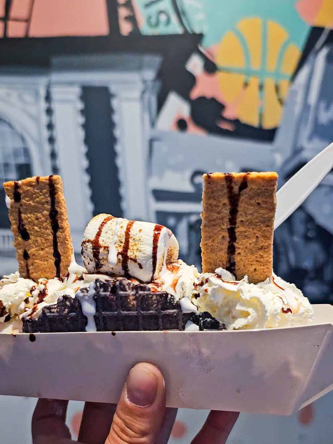 ice cream taco topped with grahams and a marshmallow