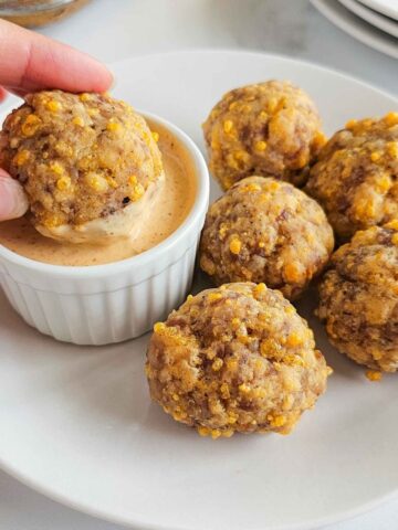 Sausage ball dipped into a sauce