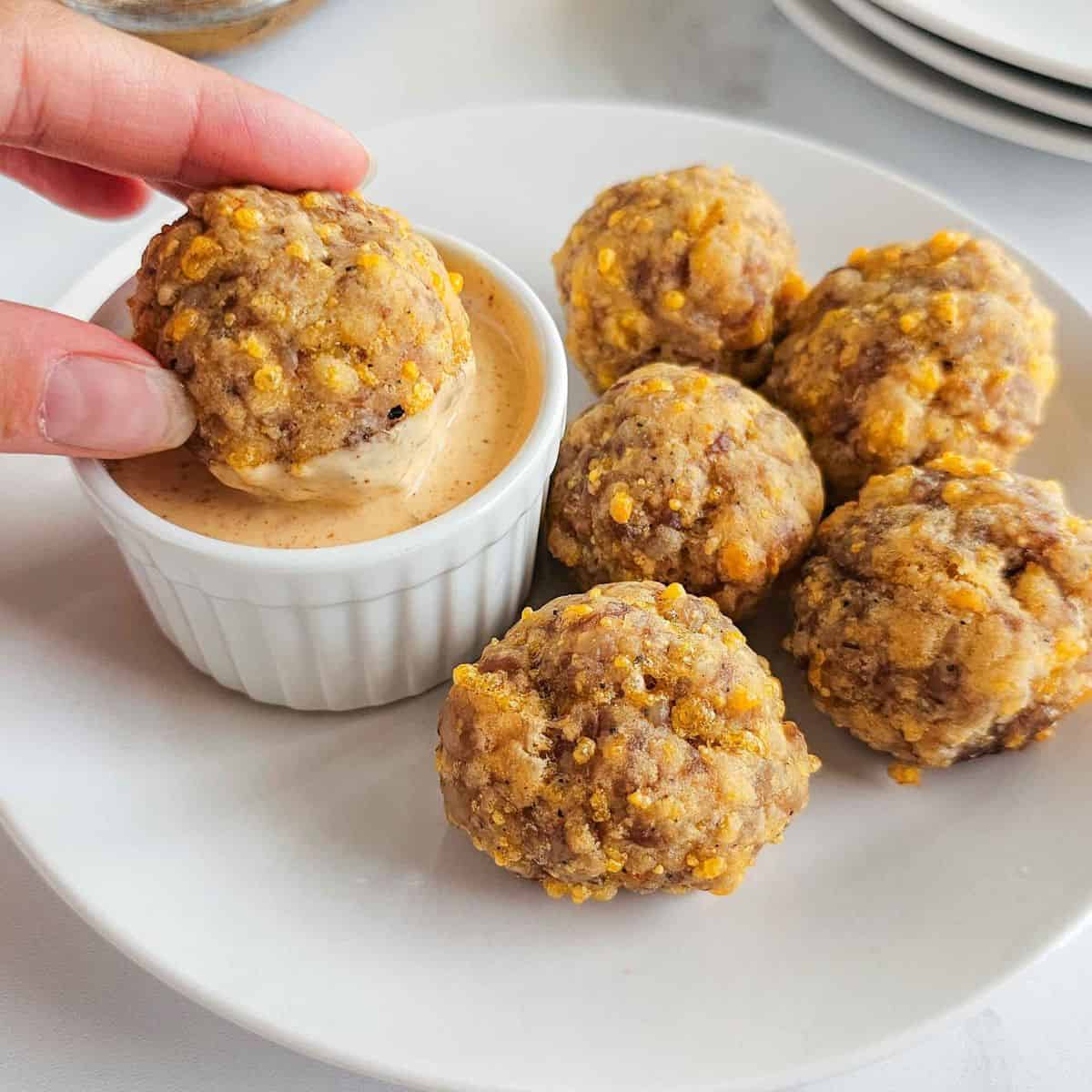 Sausage ball dipped into a sauce