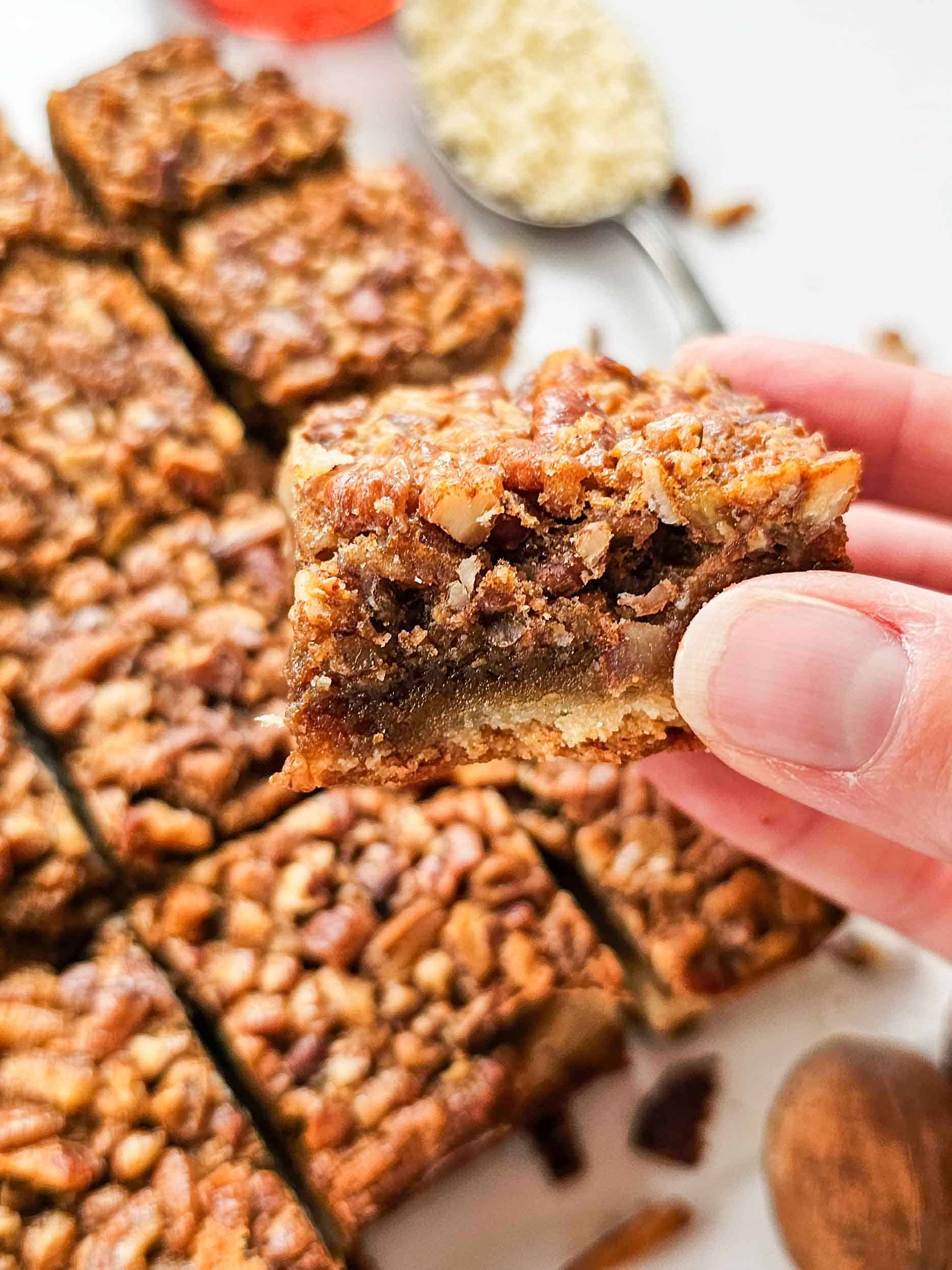 hand holding a pecan pie bar