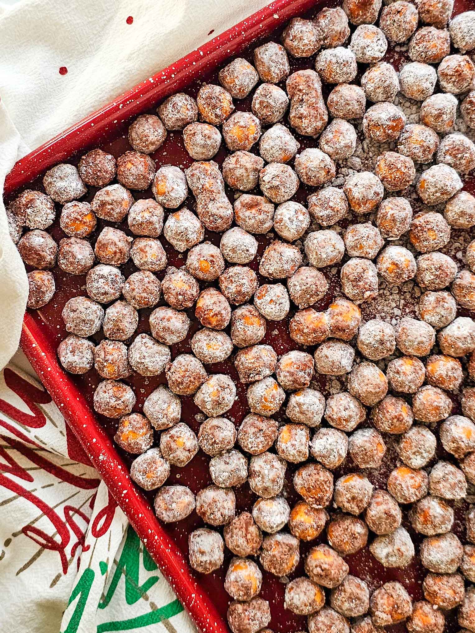 chocolate covered pretzel balls on a baking sheet