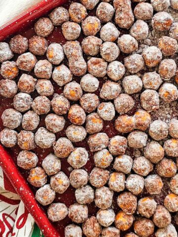 chocolate covered pretzel balls on a baking sheet