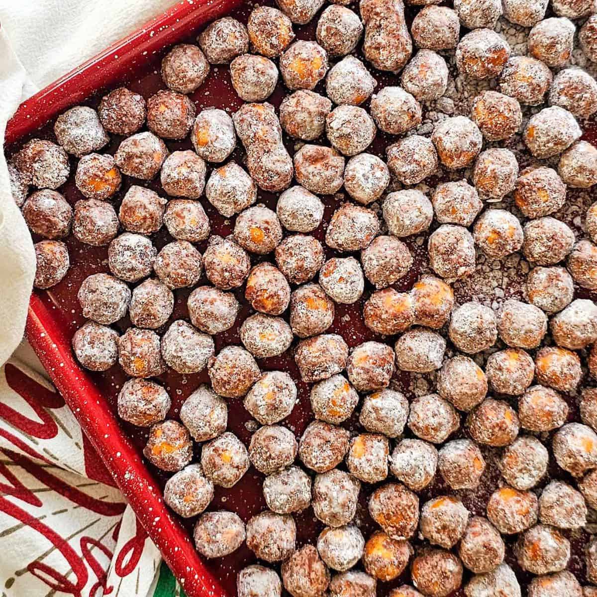 chocolate covered pretzel balls on a baking sheet